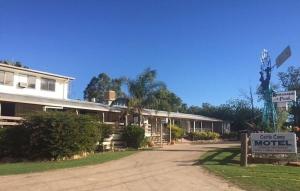 a motel sign in front of a building at Cattle Camp Motel in Taroom