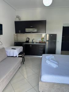 a living room with two beds and a kitchen at Vila Ervin Double Room in Ksamil