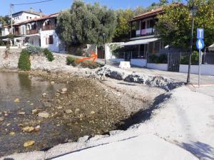 an orange object is flying over a body of water at View apartment in Lefokastro +3 photos