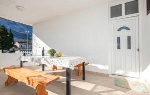 a dining room with a table and a bench at Blue Sky - jacuzzi & wine in Ožići