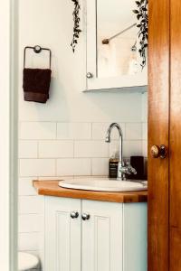 a bathroom with a sink and a mirror at The Beach Cottage Nook in Glenelg +13 photos