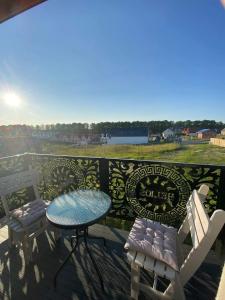 a table and chairs on a balcony with a view at Dom Gościnny Helios in Mielno