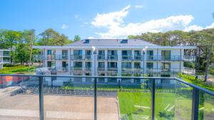 an exterior view of a building with a swimming pool at Rezydencja Niechorze D306 Classik - 5D Apartments in Niechorze