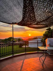 a view of a sunset from a balcony at Bella Vista in Dhíkella