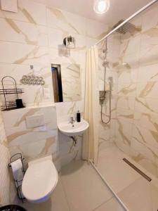 a bathroom with a toilet and a shower and a sink at Dom Gościnny Helios in Mielno +61 photos