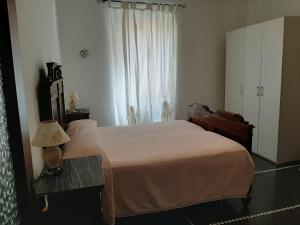 a bedroom with a large bed and a window at casa Nadia in Moneglia