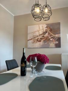 a table with a bottle of wine and a glass at Ruhrperle Apartment 3 Essen in Essen