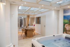 a large bathroom with a tub in a room at Saintly Chapelle in Sainte-Éanne