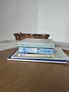 three books stacked on top of each other on a floor at Icthyoessa in Agios Kirykos