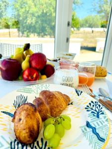 a plate of food on a table with fruit at B&B Petrae House in Ostuni