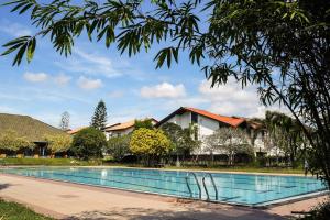 a swimming pool in front of a house at Rose Villa-AC 3 Bed rooms,15 mins to airport with gated community & swimming pool in Kotugoda