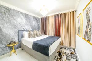 a bedroom with a king sized bed and a table at Homes of Ace Executive in Pretoria +18 photos