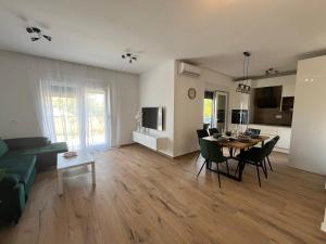 a living room with a couch and a table and chairs at Tomislav in Sukošan