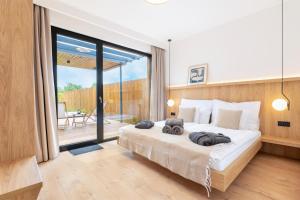 a bedroom with a bed with two towels on it at Natur Harmony Tiszafüred in Tiszafüred +56 photos