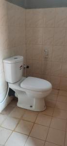 a bathroom with a white toilet in a room at Yarl Nest in Jaffna