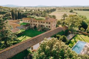 an aerial view of a mansion with a swimming pool at La Pescaia Resort in La Pescaia