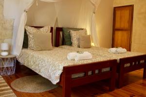 a bedroom with a bed with towels on it at Mas de l'Hermitage in Moulès