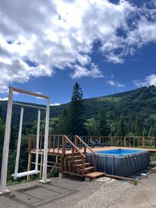 a swimming pool with a view of a mountain at Hillside in Slavske