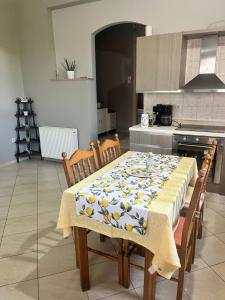 a kitchen with a table with a table cloth on it at Kampos Apartment in Chios