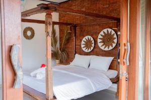 Postel nebo postele na pokoji v ubytování Bramasa Ubud Guest House + 37 fotografií