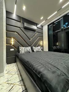 a bedroom with a large bed in a room at TuranWay Apart 1 NRG U Tower in Tashkent