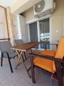 a table and chairs in a room with a window at Dimitra#RelaxHomeKallithea in Kallithea Halkidikis