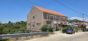 a building with a car parked in front of it at Alexia Ferentinou in Fiskardo