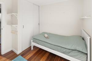 a small bed in a room with white walls at Serene Farm-Style Escape 4 Bed Home and Private Guest House  +61 photos