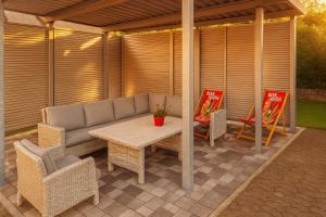 a patio with a table and wicker chairs at Appartment Schmidtner in Ansbach