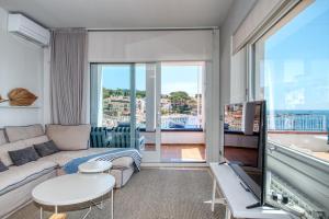 a living room with a couch and a table at House in the sea in Calella de Palafrugell