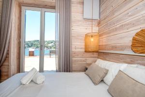 a bedroom with a bed with a wooden wall at House in the sea in Calella de Palafrugell