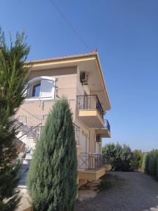 a building with a tree in front of it at Peter appartments in Vrachati