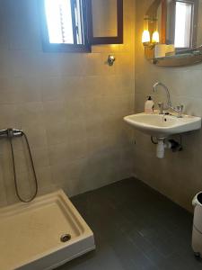 a bathroom with a sink and a toilet and a shower at Traditional Bungalows in Kalives Poligirou