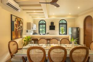 a dining room with a table and chairs at Morii Homes 4BHK Villa with private pool Parra, Assagao in Parra