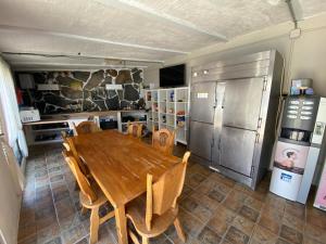 a kitchen with a wooden table and a refrigerator at Hakuna Matata in El Campello