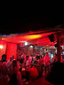 a group of people standing in a bar at night at Sol & Sea Apartments 2 in Shëngjin