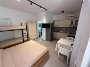a small room with a bunk bed and a kitchen at Private Houses by the Beach in Velipojë