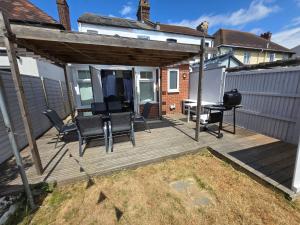 a wooden deck with a table and chairs at Blue Peak Lodge in Clacton-on-Sea