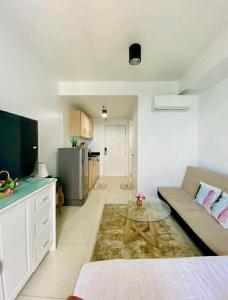a living room with a couch and a table at Tagaytay Staycation by SMDC WIND RESIDENCES LAKEVIEW in Kaybagal