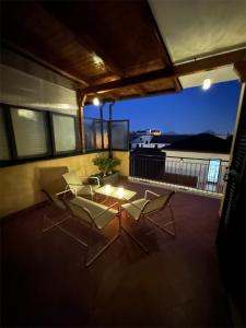 a patio with a table and chairs on a balcony at Dimora dei Colli in Pignataro Maggiore +16 photos