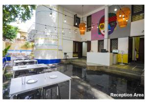 a restaurant with tables and chairs in a building at The Pune Story in Pune