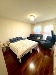 a living room with a bed and a couch at G&E Houses in Koper +18 photos