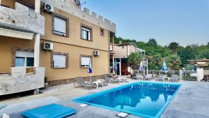 a swimming pool in front of a building at Apartments Ljiljanic in Budva