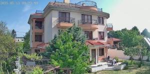 a large building with a horse in front of it at Villa B&B in Varna City