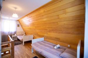 a bedroom with a large wooden wall at Apartment Lasica for 4 persons in Jasenak