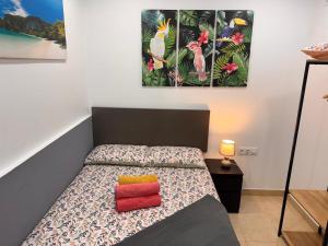 a bedroom with a bed and two paintings on the wall at 4'min to beach and tren 15 min to plaza catalunya by tren in Sant Adria de Besos