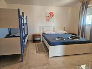 a bedroom with two beds and a bunk bed at Apartments Marija in Vir