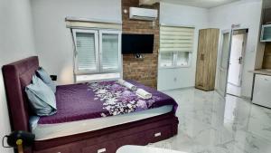 a bedroom with a bed with a window at Apartments Ljiljanic in Budva