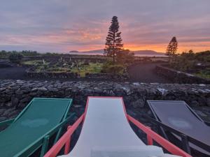a playground with a slide and a sunset in the background at Solar dos limas in Criação Velha