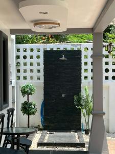 a brick wall in a patio with a table and chairs at VS PoolVilla in Ban Thang Khun